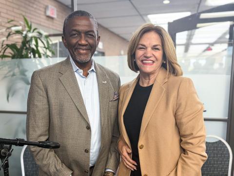 SCAG Executive Director Kome Ajise and Riverside Mayor Patricia Lock Dawson standing in a modern indoor setting.